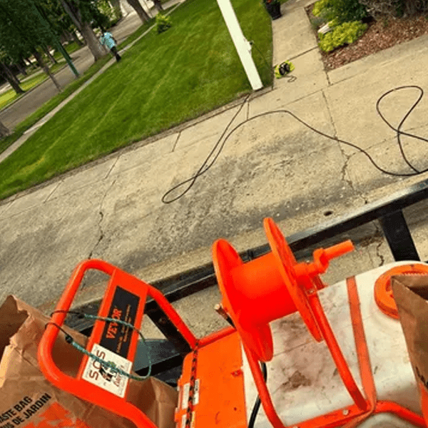 An orange utility cart with bags